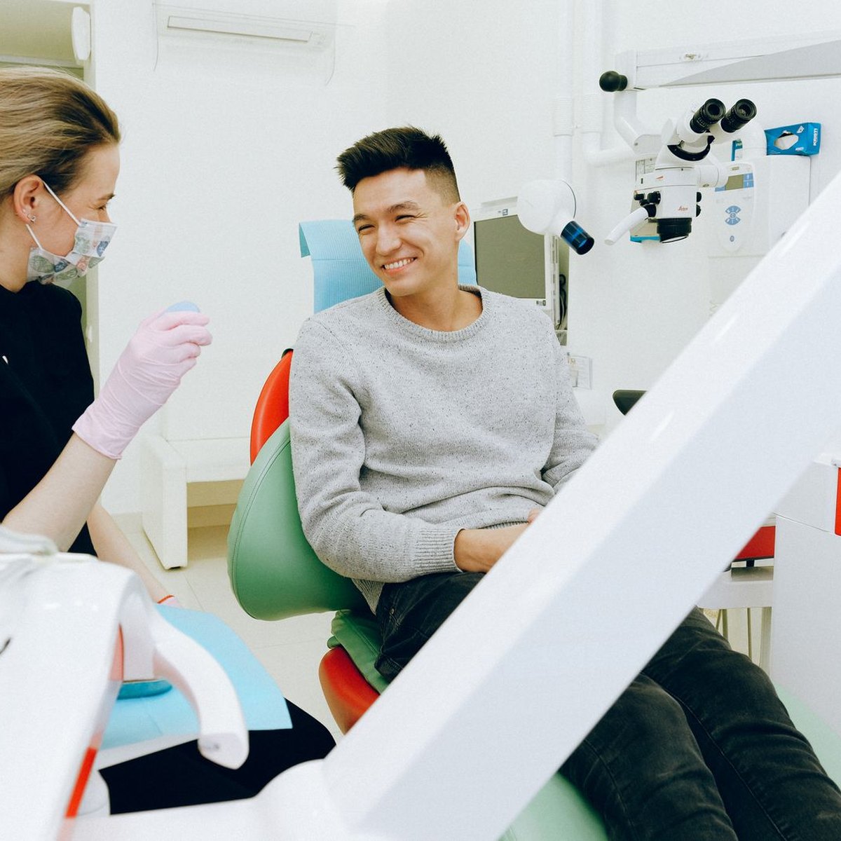 A dentist treating a patient in a modern treatment room
